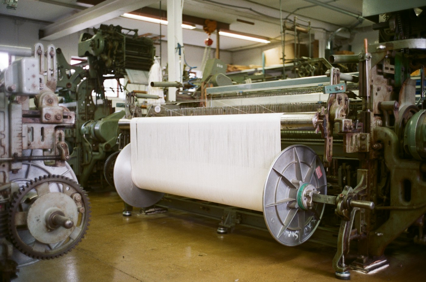 Weaving loom with a roll of finished fabric